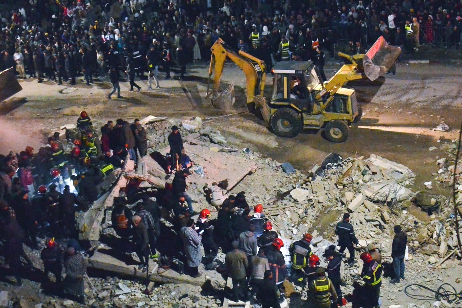 Les secours recherchent des victimes dans les décombres de deux immeubles effondrés dans le quartier Al Massira de Fès, dans la nuit du 9 décembre 2025.