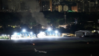 De la fumée s'élève de l'aéroport de La Carlota à Caracas, le 3 janvier 2026